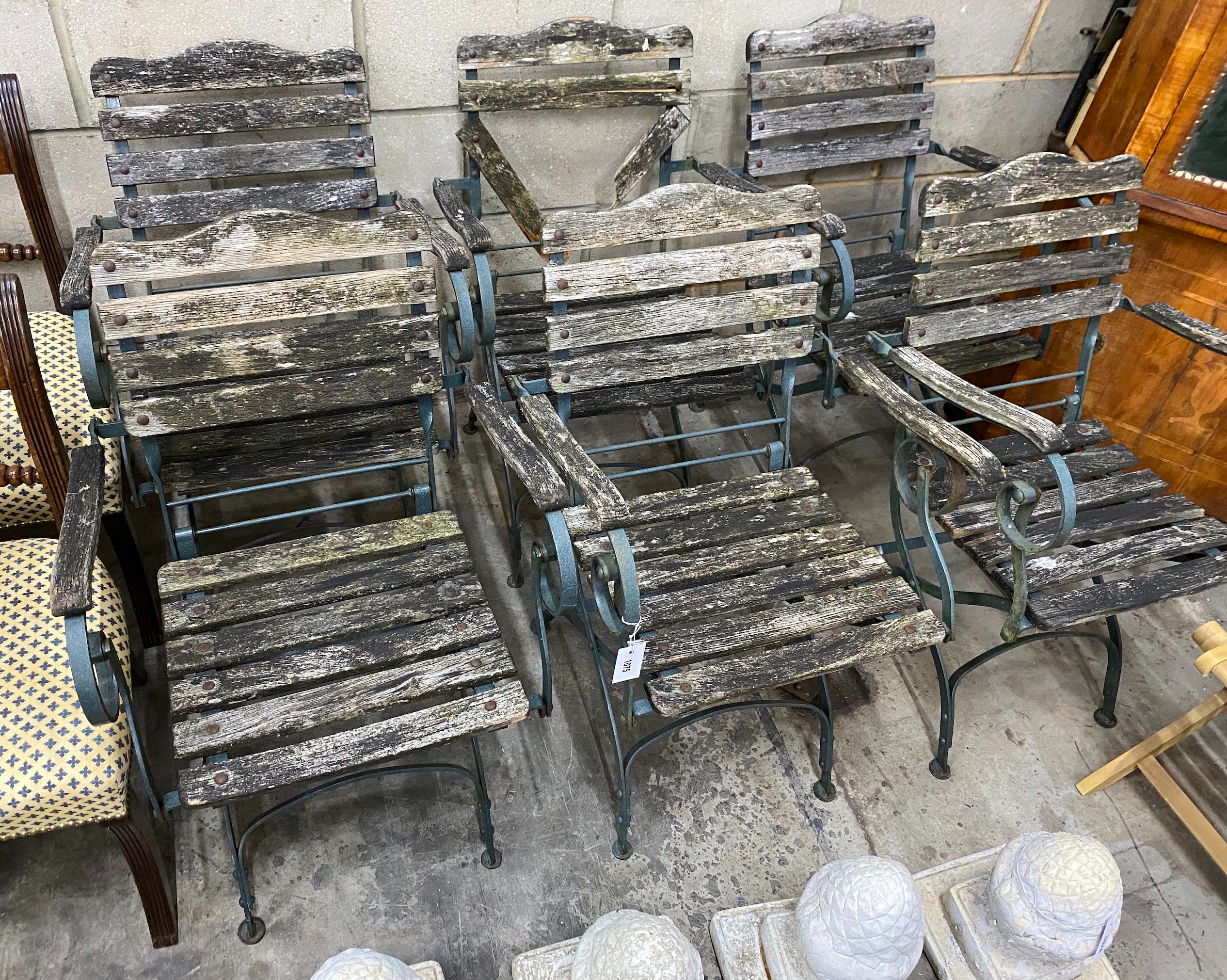 A set of six slatted wrought iron folding garden chairs